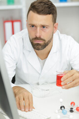 a man lab assistant conducts experiments on pc