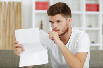 worried man reading his correspondence