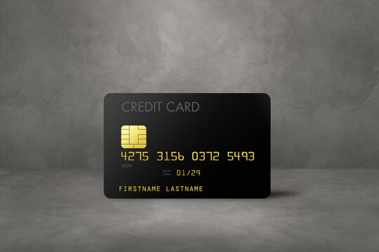 Black credit card on a concrete background