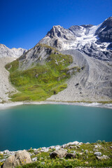 Long lake and Grande Casse Alpine glacier in French alps