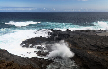 North coast of Gran Canaria, lava fields of Banaderos area, grey textured lava from eruption of Montana de Arucas, 
stormy weather in October