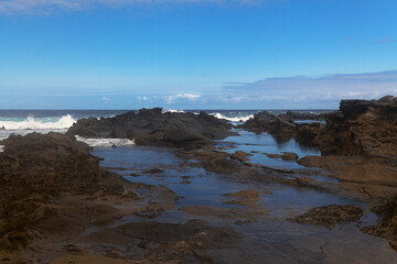 Obraz premium North coast of Gran Canaria, lava fields of Banaderos area, grey textured lava from eruption of Montana de Arucas, stormy weather in October