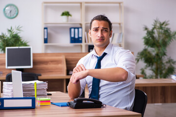 Young male employee working in the office