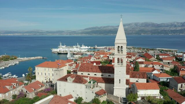 flying counter clockwise around church tower of Supetar on Brac Island Croatia