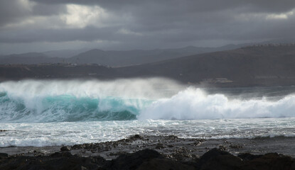 North east  coast of Gran Canaria, powerful ocean waves broought in by distant Epsilon hurricane breaking by the shore next to El Confital beach
