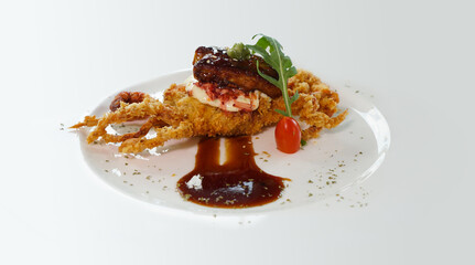 Soft shell crab deep fried with sauce on white. 