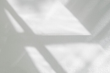 Abstract light reflection and grey shadow from window on white wall background , dark gray and sunshine diagonal geometric effect overlay for backdrop and mockup design