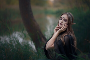 Portrait of a gentle woman elf on the river bank