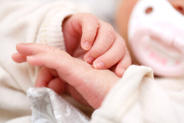 small fingers, hands of a newborn baby close-up. small depth of focus area