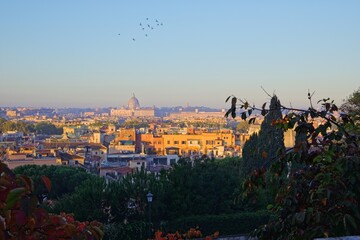 Panoramic view of Rome at sunrise with Saint Peter Basilica in the background