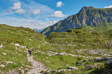 Fototapeta na wymiar Hiking through the mountains in Vorarlberg, Austria. Hiking along the Lechweg in Austria. Hiking through a lonely mountain landscape in Austria.
