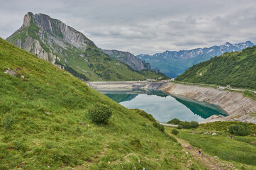 Hiking through the mountains in Vorarlberg, Austria. Hiking along the Lechweg in Austria. Hiking through a lonely mountain landscape in Austria. Hiking towards a mountain lake in Austria.