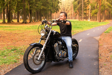 Obraz na płótnie Canvas Young man on a motorcycle, Road