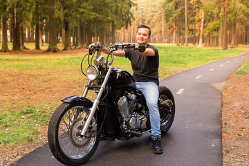 Fototapeta na wymiar Beautiful young man on a motorcycle