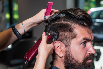 master Barber does the hairstyle and styling with electric shaver to male, Concept Barbershop
