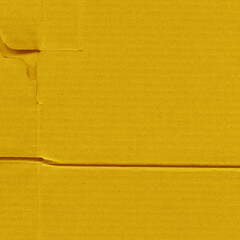 Fototapeta premium A yellow vintage rough sheet of carton. Recycled environmentally friendly cardboard paper texture. Simple and bright minimalist papercraft background.