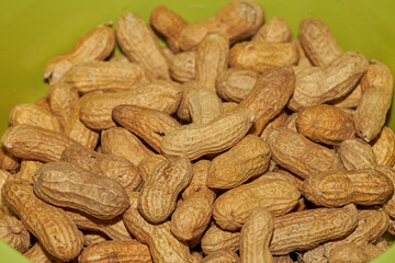 many peanuts in a green bowl