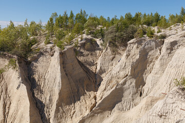 Fototapeta na wymiar Sand slopes of abandoned quarry. Rummu, Estonia