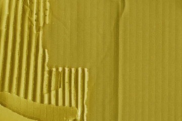 A yellow vintage rough sheet of carton. Recycled environmentally friendly cardboard paper texture. Simple and bright minimalist papercraft background.
