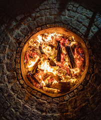 Fireplace with embers, bricked with granite stones, mobiles foto