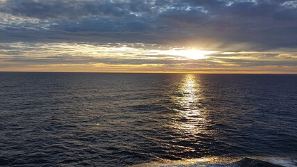 Fototapeta premium Image of a sunset on the ocean taken from a cruise ship off Norway