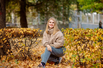 young beautiful woman in the autumn park