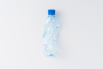 Used plastic bottle of water isolated on white background. Recycling concept. Flat lay