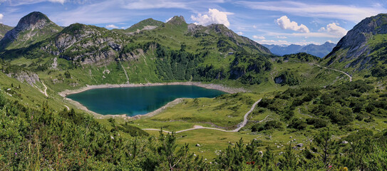 Beautiful mountain lake in Austria. Panoramic view on the Soiernsee in Vorarlberg, Austria. Panoramic mountain landscape in Vorarlberg, austria. Reflecting mountain lake in Austria.
