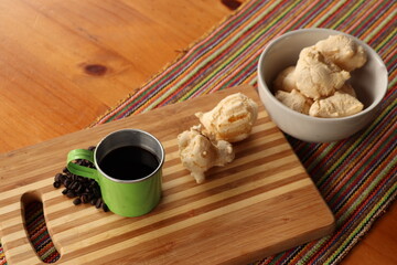 Breakfast, with starch biscuit, cheese bread, served on a wooden table outdoors. Farm breakfast. Coffee, coffee strainer on the table.