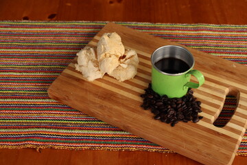 Breakfast, with starch biscuit, cheese bread, served on a wooden table outdoors. Farm breakfast. Coffee, coffee strainer on the table.