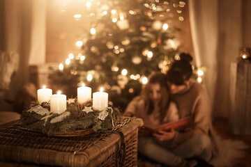 Child sits with mother in front of the Christmas tree and read a book together and look forward to Christmas, advent wreath - obrazy, fototapety, plakaty