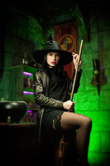 women in a hat in the witch's room on Halloween