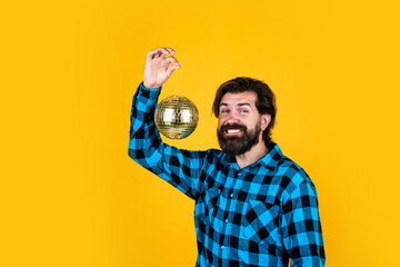 Disco man having leisure with a glittering disco mirror ball, happy mood