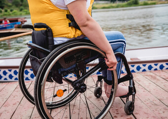 Obraz premium People with disabilities in life vests on the pier.