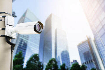 Modern public CCTV camera on electric pole with blur building background. Recording cameras for...