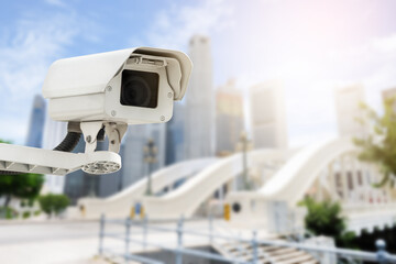 Modern public CCTV camera on wall with blur building background. Recording cameras for monitoring...