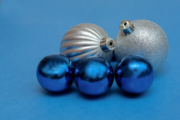 Silver and blue Christmas balls on a blue background