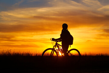Obraz na płótnie Canvas silhouette of a person with a bicycle