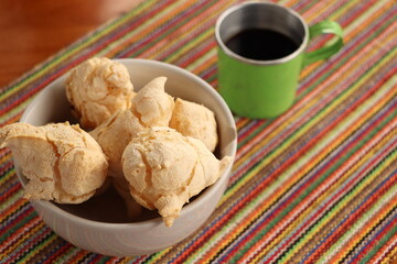 Breakfast, with starch biscuit, cheese bread, served on a wooden table outdoors. Farm breakfast. Coffee, coffee strainer on the table.