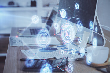 Double exposure of desktop computer and technology theme hologram. Concept of software development.