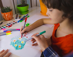 child with a teacher is engaged in art therapy