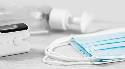 Medical concept. pulse oximeter, sanitizer and face masks. Pneumonia prevention and cure, flu...