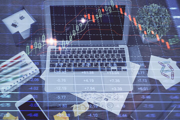 Double exposure of forex chart and work space with computer. Concept of international online trading.