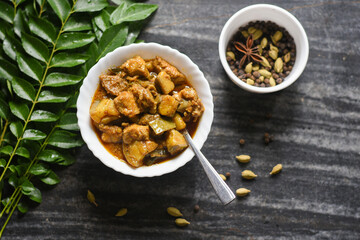Traditional homemade Pork curry from Asian cuisine. Goan Pork vindaloo. Spicy delicious meat beef curry. Bowl of tasty mutton Indian spices. side dish of Ghee rice, christian food for Christmas India