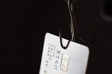 Close-up of a credit card on a fishing hook