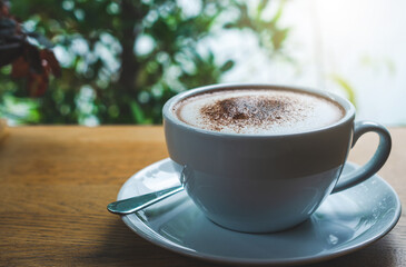 closeup coffee cup on wood table bar in restaurant or cafe with copy space. fresh beverage.