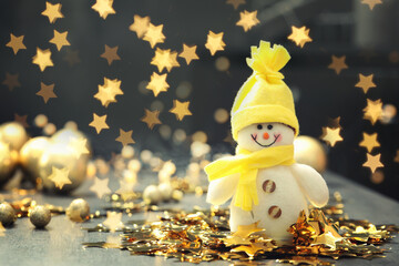 Cute snowman and Christmas decor on table, bokeh effect