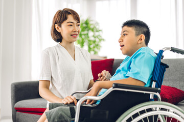 Portrait of asian physiotherapist carer helping and playing with special disabled child health problem by doing exercises sitting in wheelchair in rehabilitation clinic.disability care concept