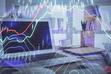 Forex market chart hologram and personal computer background. Double exposure. Concept of investment.