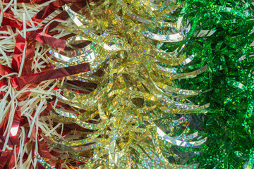 A fringed strip of a type of tissue or shiny paper that is used to decorate, especially the Christmas tree.
